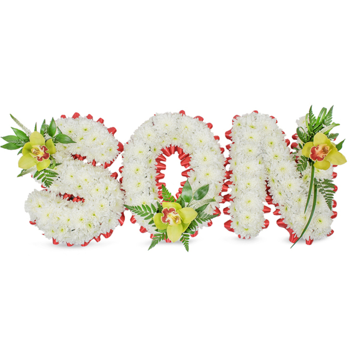 This image shows a heartfelt, handcrafted memorial spelling out SON in solid, three-dimensional letters fashioned from countless immaculate white chrysanthemums. The dense, evenly set flowers give each letter a sculpted, cloudlike volume that sits calmly against a simple white backdrop. A continuous red ribbon, folded into a scalloped edging, outlines every contour of the letters and threads through the O's inner ring, offering a vivid counterpoint to the pure white petals and signalling affection and remembrance. Carefully placed as natural punctuation are three yellow-green Cymbidium orchids with faint reddish-brown throats: one nestles into the upper left of the S, another is cradled inside the O near its base, and the third accents the upper right of the N. Their waxy textures and gentle colour lift the composition while a mix of fern fronds and long, glossy green leaves weave between and around the letters, lending air and a sense of living growth. The lighting is soft and even, revealing the tactile contrast between chrysanthemum fluff and orchid structure, and the arrangement emits a subtle, comforting green-fresh aroma. This design is clearly intended as a funeral or memorial tribute for a son - dignified, personal, and lovingly made - and is the sort of piece families in Cranford request when they want a bespoke expression of mourning and honour at services near Cranford Park or on nearby residential streets.