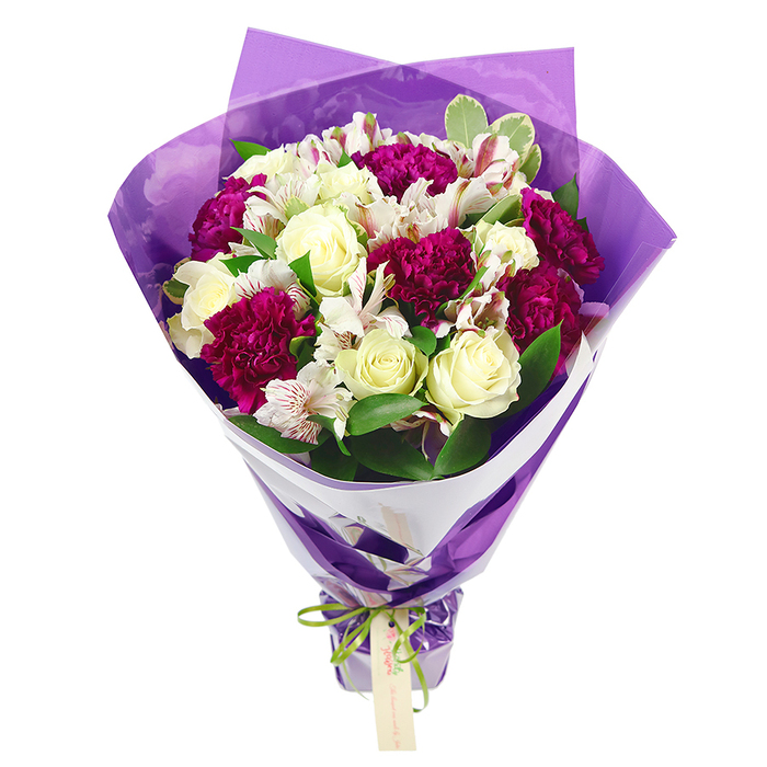 Displayed against a plain white background, this generous bouquet looks like it has just been finished on the workbench of a Cranford florist, every stem carefully placed. The flowers form a rounded, compact dome at the top, full and abundant, with creamy white roses at the centre drawing the eye. Each rose is tightly layered, the petals smooth and velvety, giving an impression of purity and calm. Surrounding and weaving between these are rich magenta carnations, their many ruffled petals creating soft shadows and depth, so that the colour seems to ripple across the arrangement. Threaded through the roses and carnations are white alstroemeria, or Peruvian lilies, their slender petals lightly flecked with pinkish-red lines and finished with dark, prominent stamens, adding a gentle, speckled charm when you imagine them up close. The blooms are cushioned by an array of fresh green leaves, some solid emerald, others touched with pale variegation along the edges, bringing a lively contrast that makes the whites and magentas glow more brightly. The stems are drawn together firmly, tapering from the lush top into a tidy base that hints at the bouquet being easy to cradle in two hands as it's carried along Cranford High Street. Around the flowers, an inner layer of crisp white paper forms a neat collar that echoes the background, while an outer wrap of translucent purple cellophane crinkles softly, creating a shimmering halo of colour around the blooms. At the base, a bright, iridescent green satin ribbon is knotted into a neat bow, its sheen catching the light, with a small, rectangular, light brown tag dangling invitingly, ready for a name or a short message. The overall feel is one of cheerful celebration and thoughtful care, suitable for birthdays, thank-you gifts, or simply sending a little brightness to someone's day in Cranford.