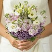There is an enchanting tranquility to this bridal bouquet, its every detail thoughtfully placed by a passionate florist from Cranford. Cascades of creamy white Lisianthus, their ruffles light as whipped cream, nestle beside pale pink and lilac stock blossoms, each one diffusing a subtle, sweet fragrance reminiscent of Cranford's hidden gardens in full bloom. The bouquet is set apart by a striking edge of deep purple, star-shaped Allium, the blooms arranged at the base like a jewelled collar, lending the design both drama and contemporary poise. Slender bands of bear grass, fresh and verdant, spiral around the stems, creating gentle movement and structure-echoing the gentle sloping paths along Cranford's riverside parks. The bride's hands, polished in a barely-there pink, cradle the bouquet with anticipation, against the soft, dreamy backdrop of an ivory gown just out of focus. Daylight glimmers over each bloom, amplifying their pastel sheen and highlighting subtle shifts in tone and texture. Crafted for a Cranford celebration-perhaps a spring ceremony in Cranford Park-the bouquet embodies romance, serenity, and the hopefulness that marks every new beginning. Its artistry, grounded in local expertise, creates an arrangement that feels timeless, personal, and utterly enchanting.